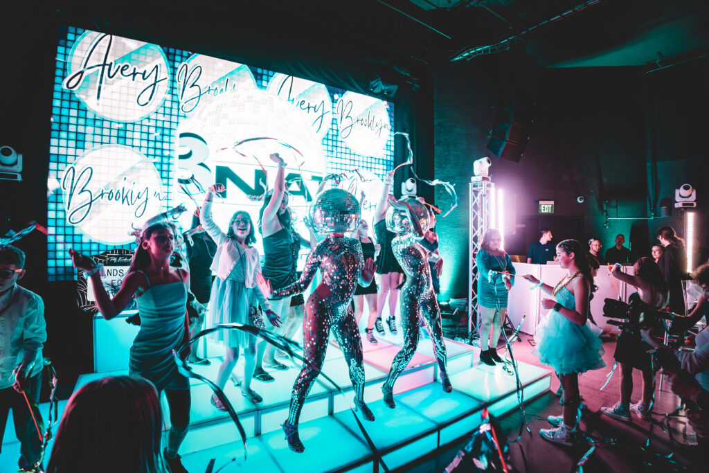 Disco ball dancer performing at a luxury event in Boston, wearing a reflective mirrored costume and captivating guests with dazzling light effects; perfect entertainment for private parties, corporate events, and celebrations in major cities like New York, Los Angeles, and Miami.