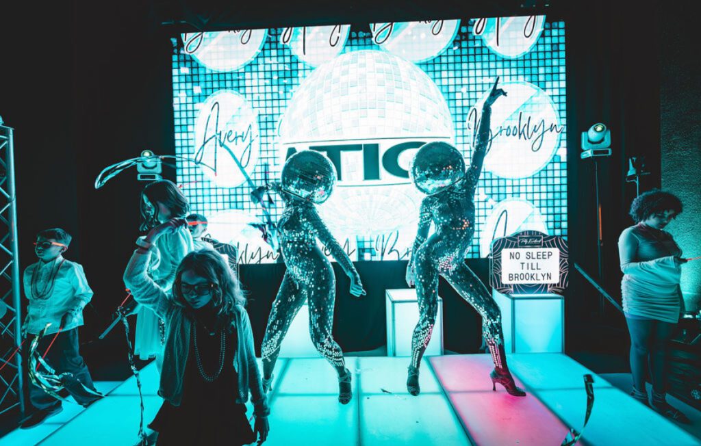 Disco ball dancer performing at a luxury event in Boston, wearing a reflective mirrored costume and captivating guests with dazzling light effects; perfect entertainment for private parties, corporate events, and celebrations in major cities like New York, Los Angeles, and Miami.