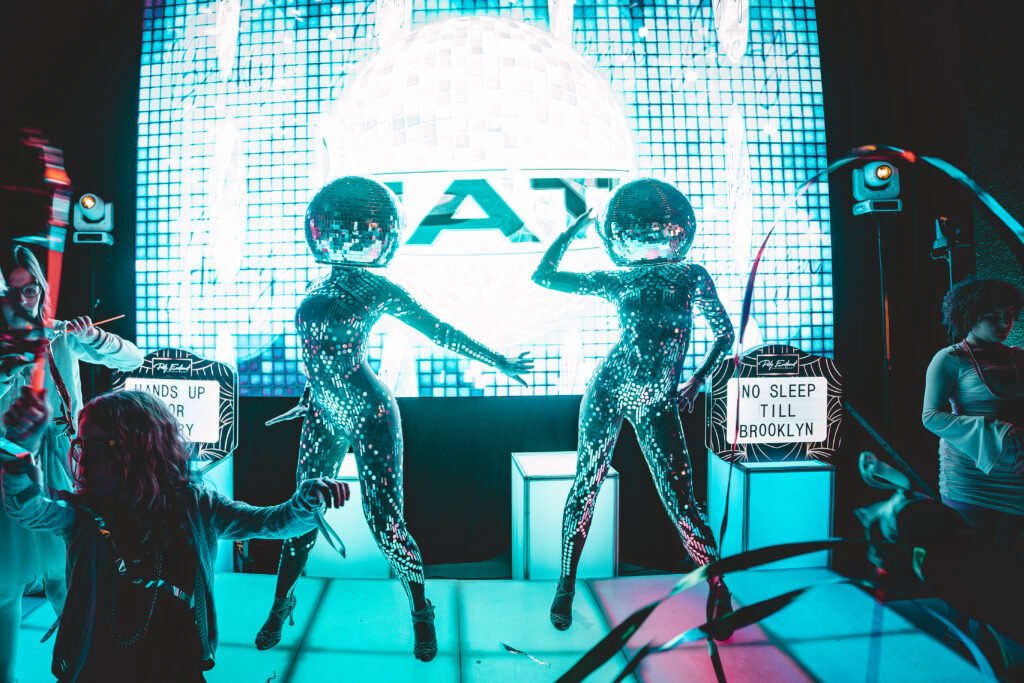 Disco ball dancer performing at a luxury event in Boston, wearing a reflective mirrored costume and captivating guests with dazzling light effects; perfect entertainment for private parties, corporate events, and celebrations in major cities like New York, Los Angeles, and Miami.