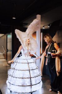 Strolling champagne skirt diva serving champagne at a high-end event in Boston, wearing an elegant costume and engaging guests with a unique interactive experience; ideal entertainment for weddings, corporate events, and luxury celebrations in cities like New York, Chicago, and Miami.